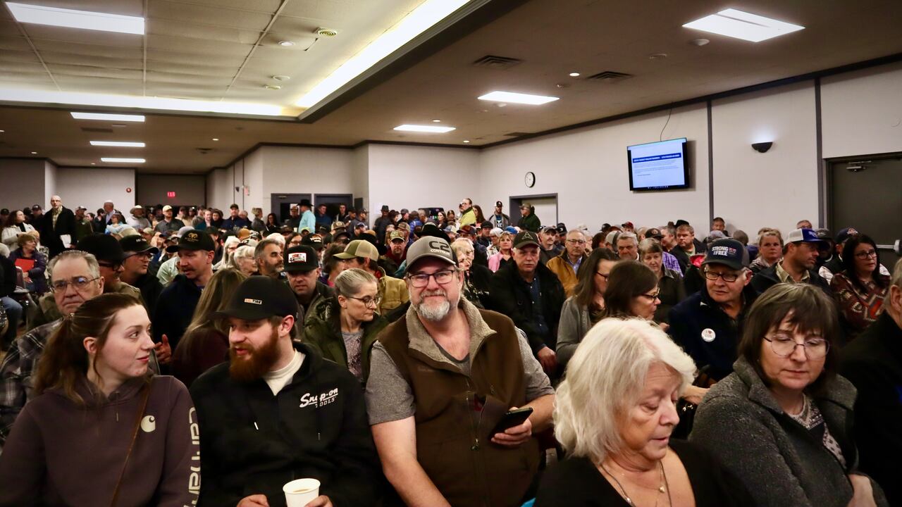 Farmers and community members gathered inside a rural town hall meeting.